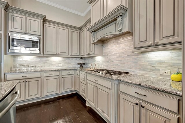 kitchen with crown molding, custom exhaust hood, stainless steel appliances, decorative backsplash, and dark wood-style floors
