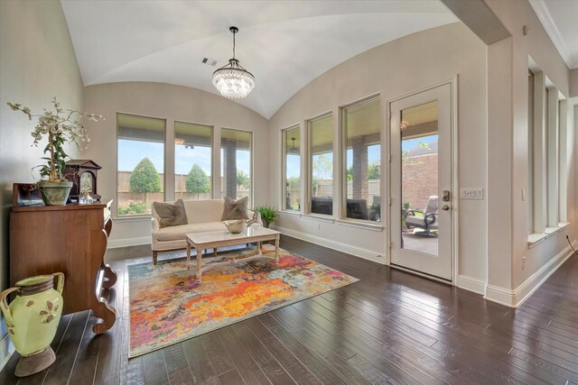 living room featuring an inviting chandelier, hardwood / wood-style floors, baseboards, lofted ceiling, and visible vents