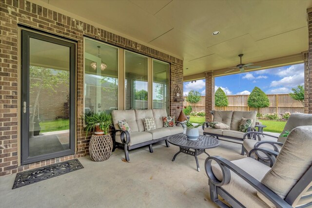 view of patio / terrace featuring an outdoor living space, ceiling fan, and fence