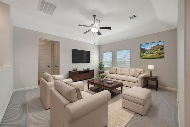 living room with baseboards, a ceiling fan, light colored carpet, and visible vents