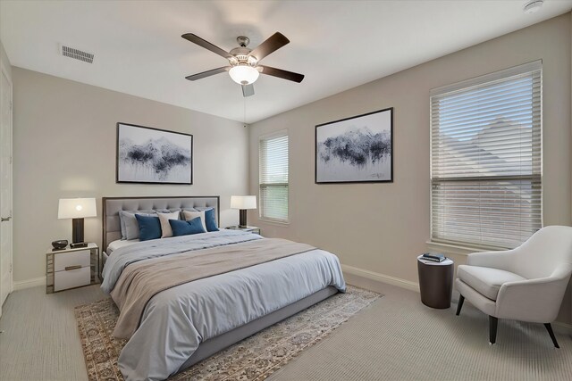 bedroom featuring visible vents, a ceiling fan, baseboards, and carpet floors