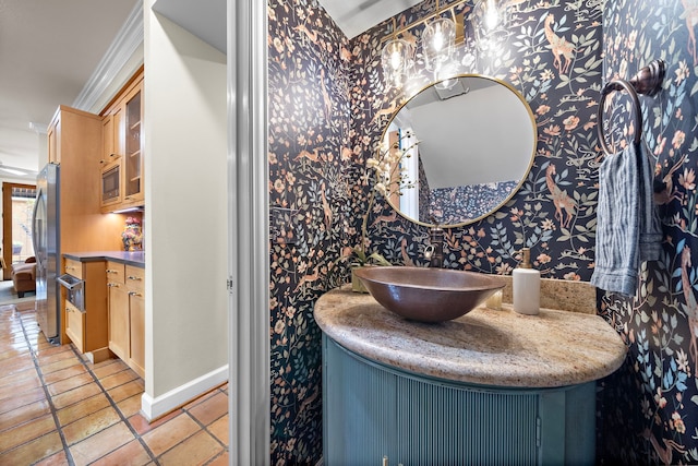 bathroom with vanity, baseboards, wallpapered walls, and tile patterned floors