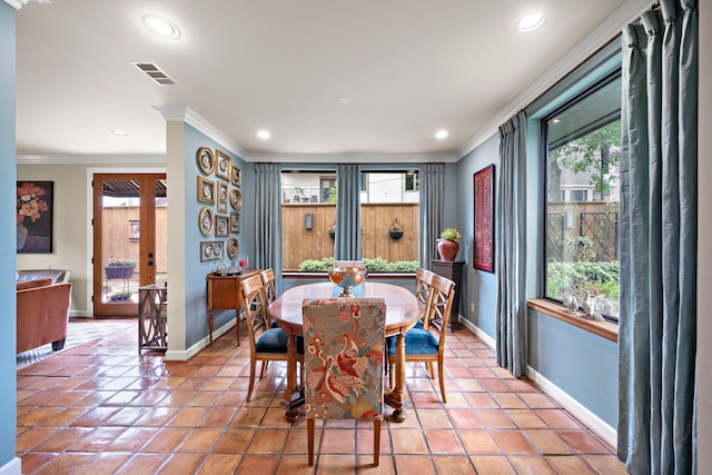 dining room featuring baseboards, ornamental molding, and a healthy amount of sunlight