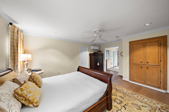 bedroom featuring ceiling fan, crown molding, light wood-type flooring, an AC wall unit, and recessed lighting