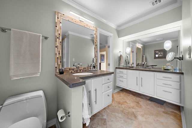 full bathroom featuring visible vents, two vanities, a sink, toilet, and ornamental molding