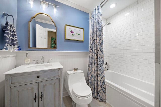 full bathroom featuring vanity, crown molding, wainscoting, toilet, and shower / bathtub combination with curtain