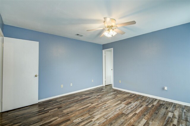 unfurnished room featuring a ceiling fan, baseboards, visible vents, and wood finished floors
