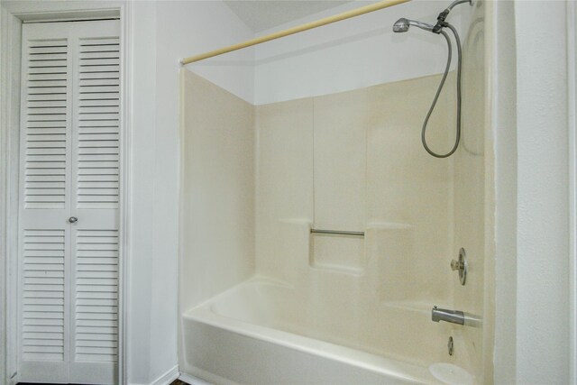 bathroom with shower / washtub combination and a closet