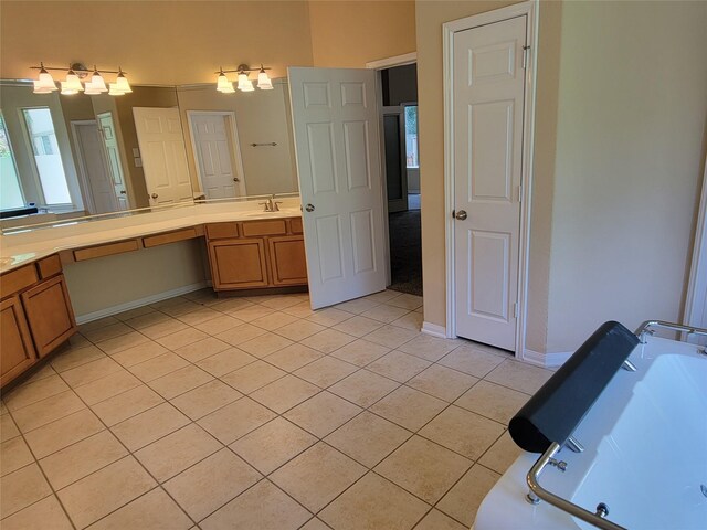 full bath with a tub, tile patterned floors, baseboards, and vanity