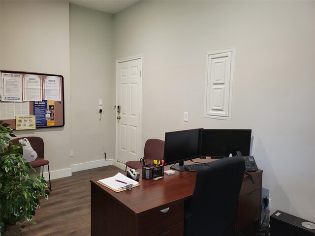home office with baseboards and dark wood-type flooring