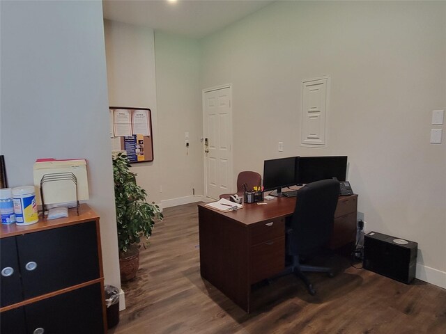 office area featuring baseboards and dark wood finished floors