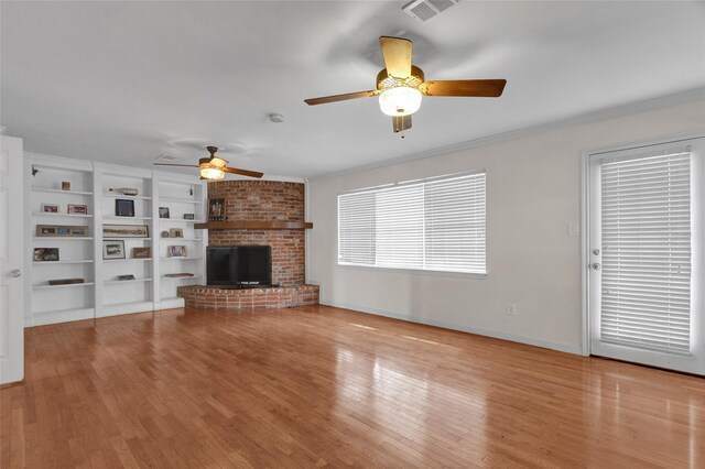 unfurnished living room featuring visible vents, a ceiling fan, wood finished floors, and a fireplace