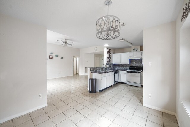 kitchen featuring white cabinets, light tile patterned flooring, tasteful backsplash, stainless steel dishwasher, and white range with gas cooktop