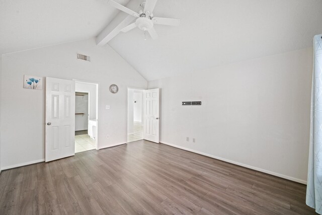 unfurnished bedroom with dark wood-style flooring, baseboards, visible vents, and beam ceiling