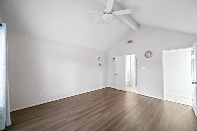 unfurnished living room with a ceiling fan, baseboards, dark wood finished floors, and lofted ceiling with beams