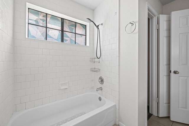 full bath featuring tile patterned flooring, baseboards, and shower / washtub combination