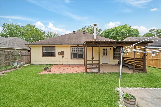 back of house with a fenced backyard, a pergola, a yard, and a patio area