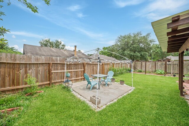 view of yard featuring a patio and a fenced backyard