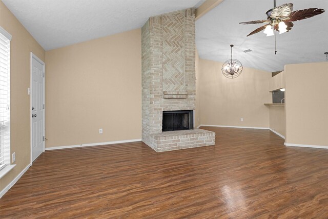 unfurnished living room featuring baseboards, wood finished floors, ceiling fan with notable chandelier, and a fireplace
