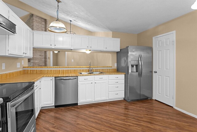 kitchen featuring a sink, appliances with stainless steel finishes, white cabinets, and dark wood-style floors