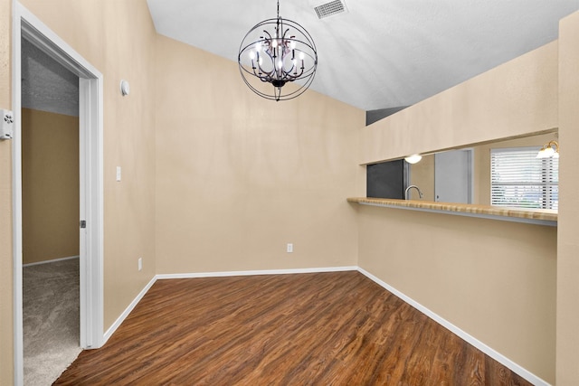 unfurnished dining area featuring a chandelier, baseboards, lofted ceiling, dark wood-type flooring, and visible vents