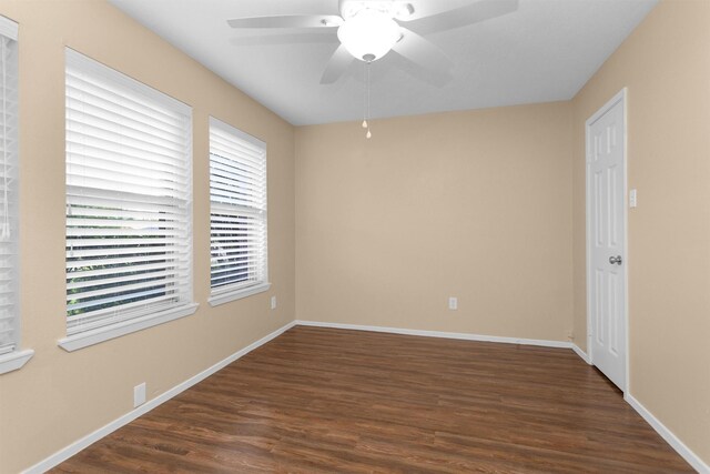 empty room with baseboards, ceiling fan, and wood finished floors