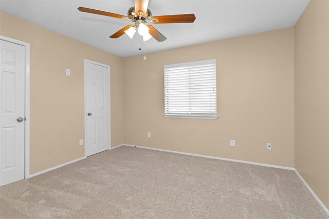 unfurnished bedroom with baseboards, a ceiling fan, and carpet flooring