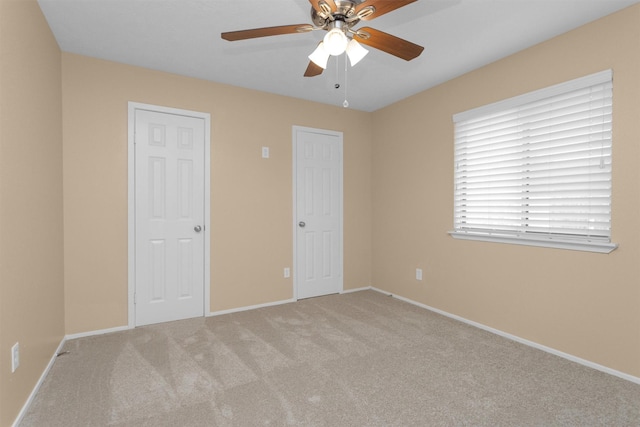 unfurnished bedroom featuring carpet flooring, baseboards, and ceiling fan