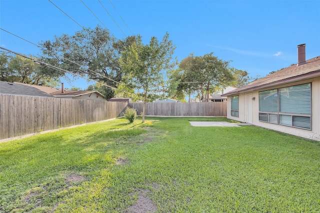 view of yard featuring a patio and a fenced backyard