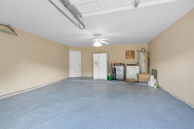 garage featuring a ceiling fan, water heater, washer and clothes dryer, and white fridge with ice dispenser