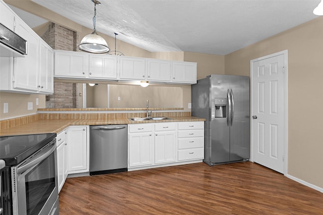 4807 Bridgemont Ln, Spring, TX 77388 - kitchen with appliances with stainless steel finishes, a sink, dark wood-style floors, and white cabinetry