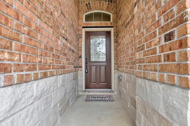property entrance with brick siding