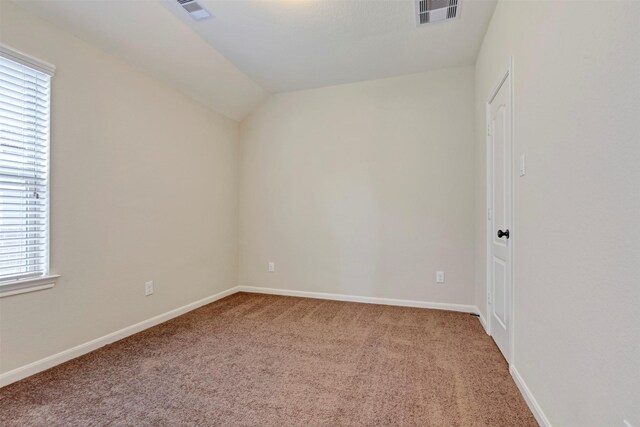 carpeted spare room with visible vents, baseboards, and a healthy amount of sunlight