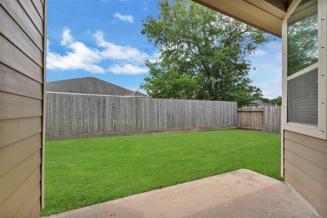 view of yard featuring a patio and a fenced backyard