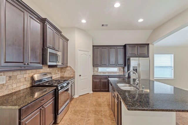kitchen featuring a sink, dark brown cabinetry, stainless steel appliances, and visible vents