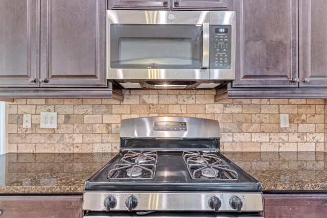 kitchen with stainless steel appliances, dark brown cabinets, and tasteful backsplash