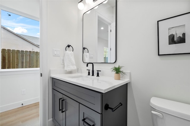 4305 Stassen St, Houston, TX 77051 - bathroom with vanity, baseboards, toilet, and wood finished floors