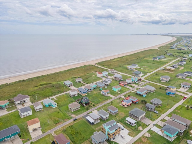 birds eye view of property with a water view, a residential view, and a view of the beach