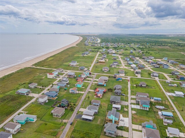 drone / aerial view with a residential view, a beach view, and a water view