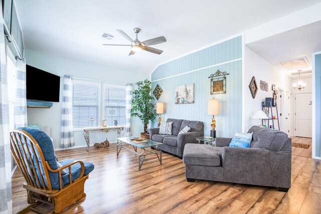 living room with visible vents, a ceiling fan, lofted ceiling, and wood finished floors