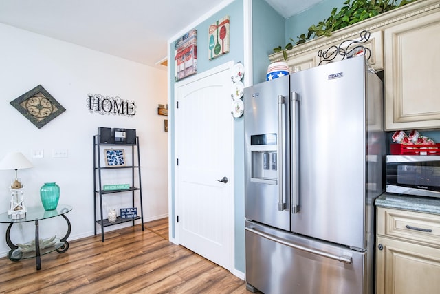 143 Ocean View Dr, Crystal Beach, TX 77650 - kitchen featuring appliances with stainless steel finishes, cream cabinets, and light wood finished floors