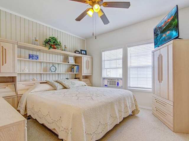 bedroom with light colored carpet, baseboards, and ceiling fan