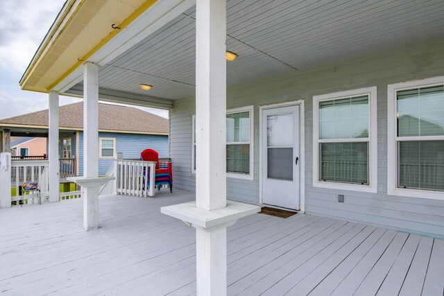wooden terrace featuring covered porch