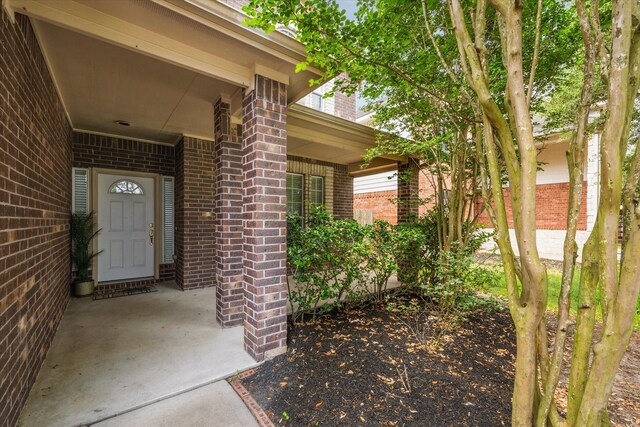 entrance to property with brick siding