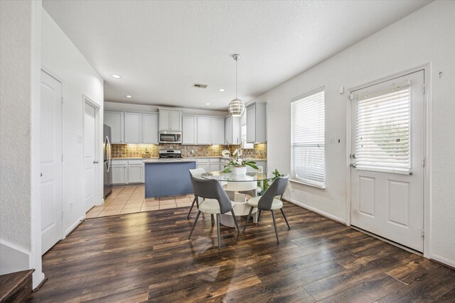dining space with recessed lighting, visible vents, and wood finished floors