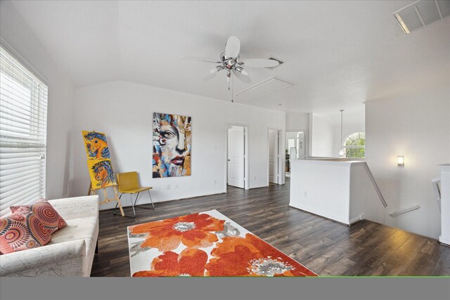 living area with visible vents, attic access, a ceiling fan, and wood finished floors