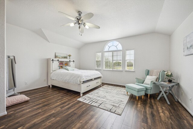 bedroom featuring ceiling fan, a textured ceiling, baseboards, wood finished floors, and vaulted ceiling