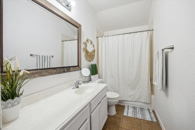 full bathroom featuring vanity, tile patterned flooring, baseboards, and toilet