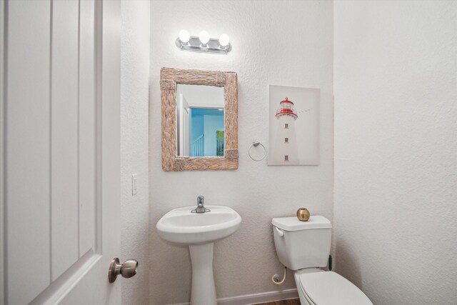 half bathroom featuring toilet