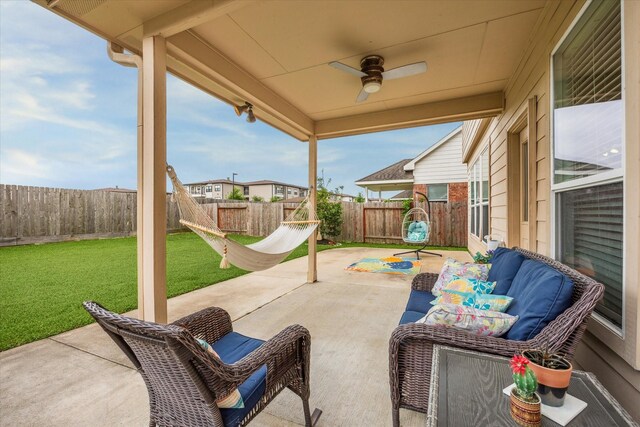 view of patio with a fenced backyard, ceiling fan, and outdoor lounge area